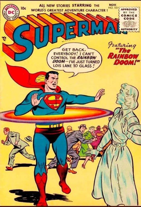 A very strange Superman comic book cover, circa 1955, with Superman standing with a rainbow surrounding his waist in front of a glass Lois Lane and a fleeing crowd. Superman is exclaiming "Get back, everybody! I can't control the Rainbow Doom -- I've just turned Lois Lane to glass!"