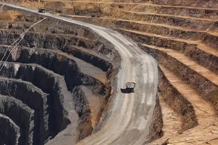 Two trucks transport gold ore from Barrick Cowal Gold Mine in New South Wales, Australia. Jason Benz Bennee/Shutterstock