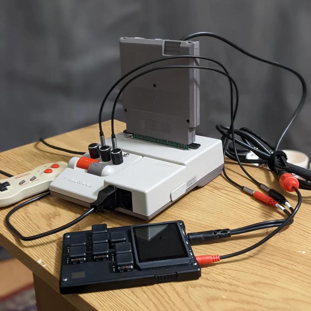 Famicom AV with a MIDINES cartridge. An M8 is connected to a pair of audio outputs on the Famicom and is also plugged into the MIDINES MIDI connector.