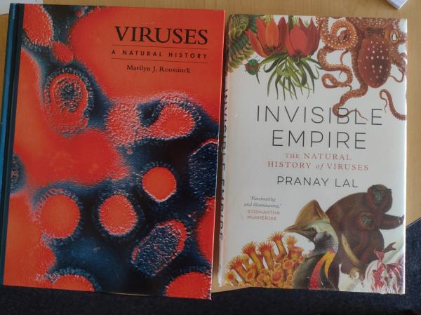 Picture of two books: "viruses, a natural history" by Marilyn Roossinck and "invisible empire" by Pranay Lal
