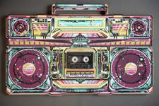 Flat lay of a boom box with purple, turquoise and yellow 1980s patterns