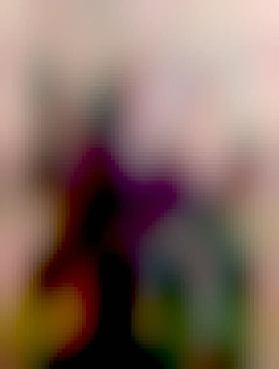 A cute black cat, Bart, sat in centre frame looking slightly off to the left. On his back is perched a small brown toy otter, that he hasn't noticed.