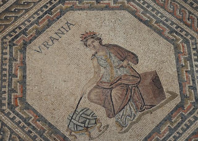 "The Vichten mosaic depicting the mythological and literary theme of the nine Muses with Calliope, the Muse of epic and elegiac poetry together with Homer in the large central medallion, around 240 AD, National Museum of History and Art, Luxembourg."

Carole Raddato / Following Hadrian, CC BY-SA 2.0, via Flickr