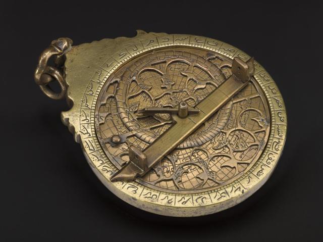 Brass planispheric astrolabe engraved with Arabic script (~1650).

Science Museum Group, CC BY-NC-SA 4.0 via Islamic astrolabe, 1645-1655. 1938-427 Science Museum Group Collection Online. https://collection.sciencemuseumgroup.org.uk/objects/co56821/islamic-astrolabe-1645-1655-astrolabe