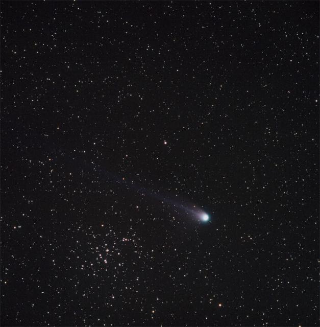 Comet C/2001 Q4 (NEAT) next to Messier 44.

Oliver Stein, CC BY-SA 3.0, via Wikimedia Commons.