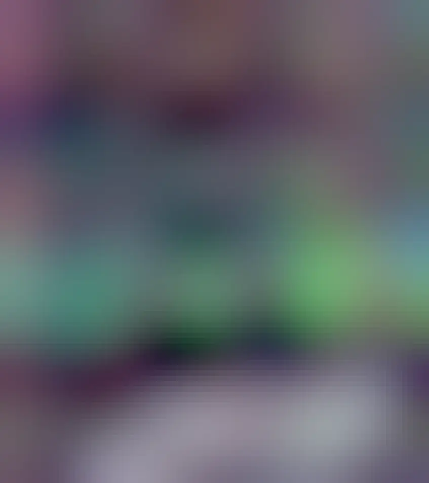 Multi-colored aurora are seen above an unusual stone gateway, the first of several similar gateways seen in the distance.