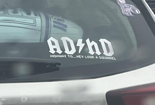 In AC/DC font, the sticker says: AD/hD HIGHWAY TO…HEY LOOK A SQUIRREL