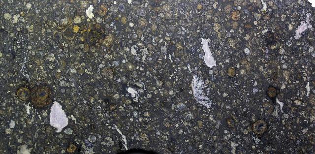 A slice of the Allende Meteorite, observed to fall on February 8, 1969 in Chihuahua, Mexico.

James St. John, CC BY 2.0, via Wikimedia Commons.