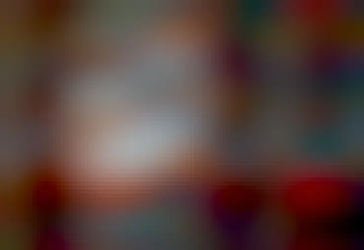 A bright gaseous nebula is pictured in front of a star field. To some, the outline of the nebula make it look like a running chicken. Dark knots of dust are seen near the bright nebula's center.