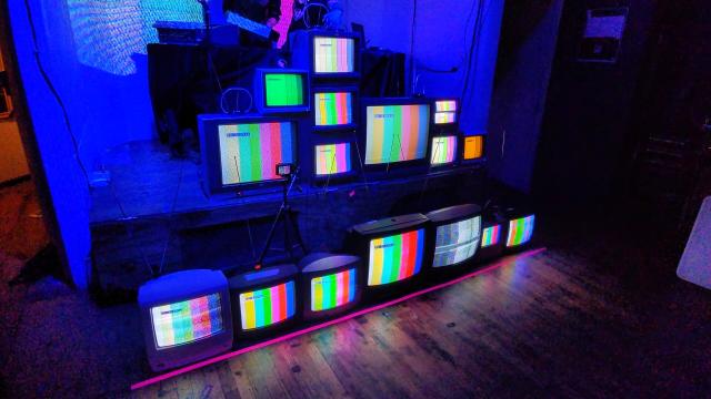 The same CRTs but all turned on and displaying "no signal" colorbars