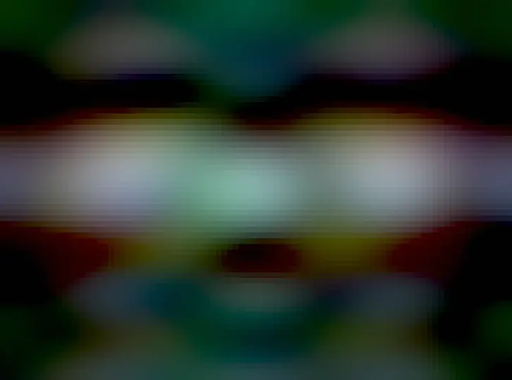 An elongated colorful nebula is shown elongated horizontally and pinched in the middle. In the very center is a bright source.