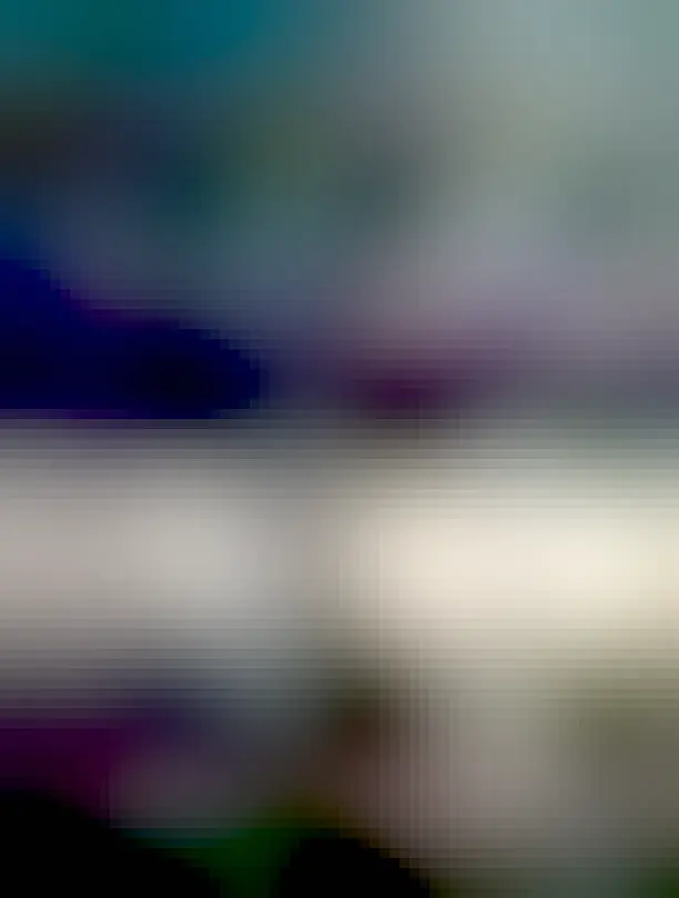 A thin gray funnel cloud is pictured connecting water at the bottom to a cloud near the top.