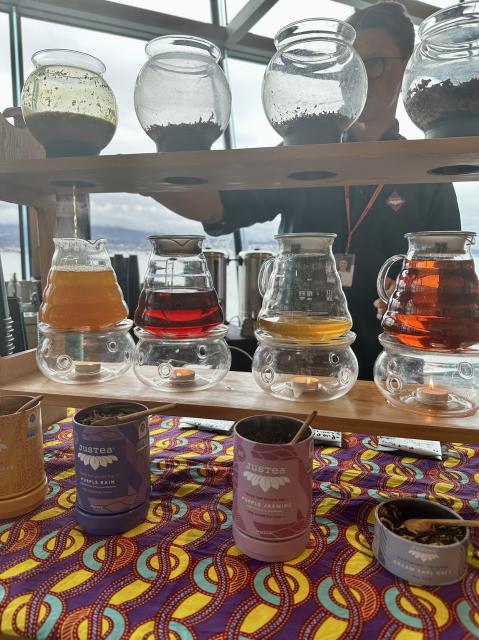 Four different colored teas being brewed in glass pots at TED.
