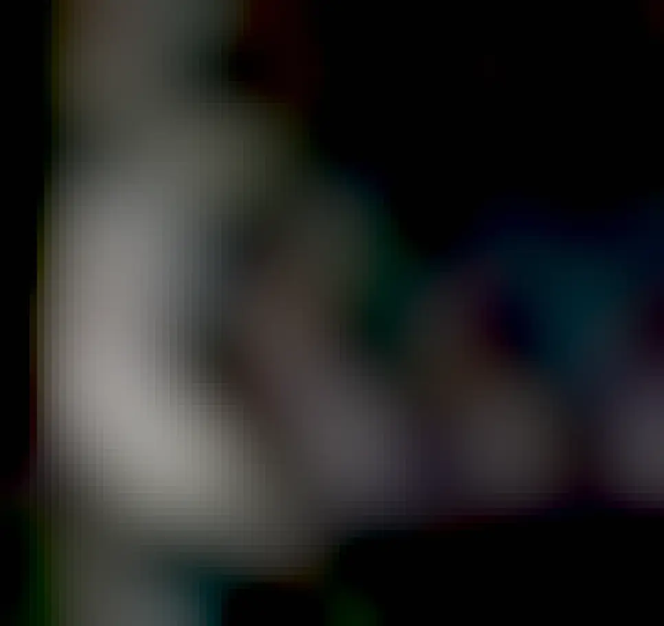 An oblong moon is shown in very muted colors, appearing almost gray. The background is deep space and completely dark at this short exposure time.