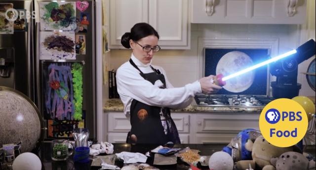 Screen shot from PBS episode of Serving Up Science. I am dressed as Leia with an apron and lightsaber.