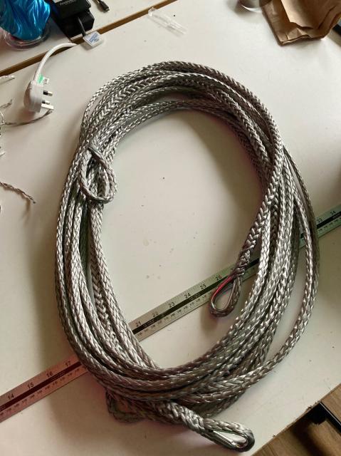 A coil of two silver-grey ropes. Eyes are spliced into the ends, and two of the ends have thimbles.