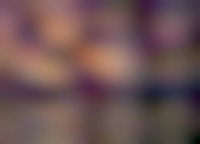 A person in silhouette looks out over a desert punctuated by unusual rock formations. High above is a colorful sky including the band of our Milky Way Galaxy and the Rho Ophiuchi star clouds.