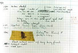 A dead moth taped to a page of handwritten code by Grace Hopper.
