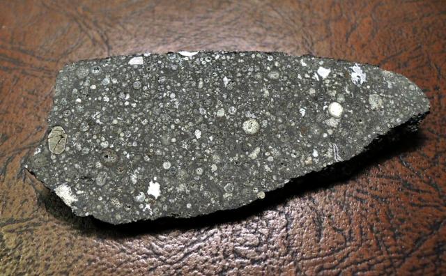 A slice of the Allende Meteorite, observed to fall on February 8, 1969 in Chihuahua, Mexico.

Jon Taylor, CC BY-SA 2.0, via Flickr: https://flic.kr/p/hHBjWN

Color edits.