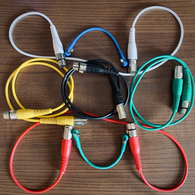 A bunch of cables arranged on a desk forming the merveilles logo