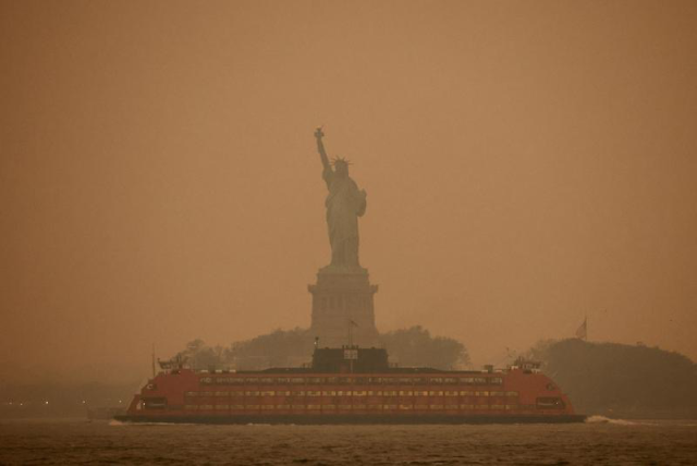 Statue of Liberty as seen through the yellow smoke coming from Canadian wildfire. 