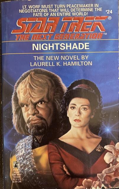 Cover of the TNG novel Nightshade (1992) by Laurell K. Hamilton, showing Worf, a flowering plant, and a blue planet in the background.

Tagline reads:

LT. WORF MUST TURN PEACEMAKER IN NEGOTIATONS THAT WILL DETERMINE THE 124 FATE OF AN ENTIRE WORLD!