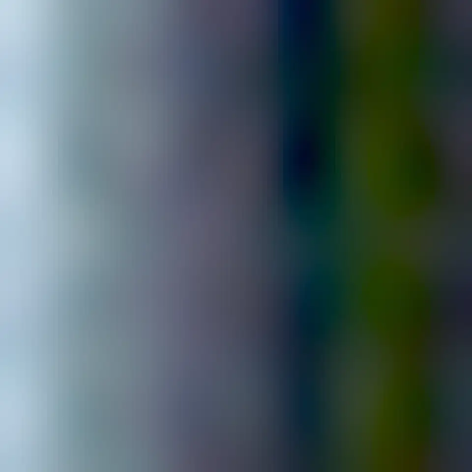 A large swirling cloud on Jupiter is shown with a bright green spot near its top. The cloud is surrounded by other less descript parts of Jupiter's upper atmosphere.