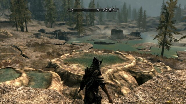 Skyrim screencap showing a warrior approaching steaming sulphur pools and ruins in the distance, where enemies are indicated.