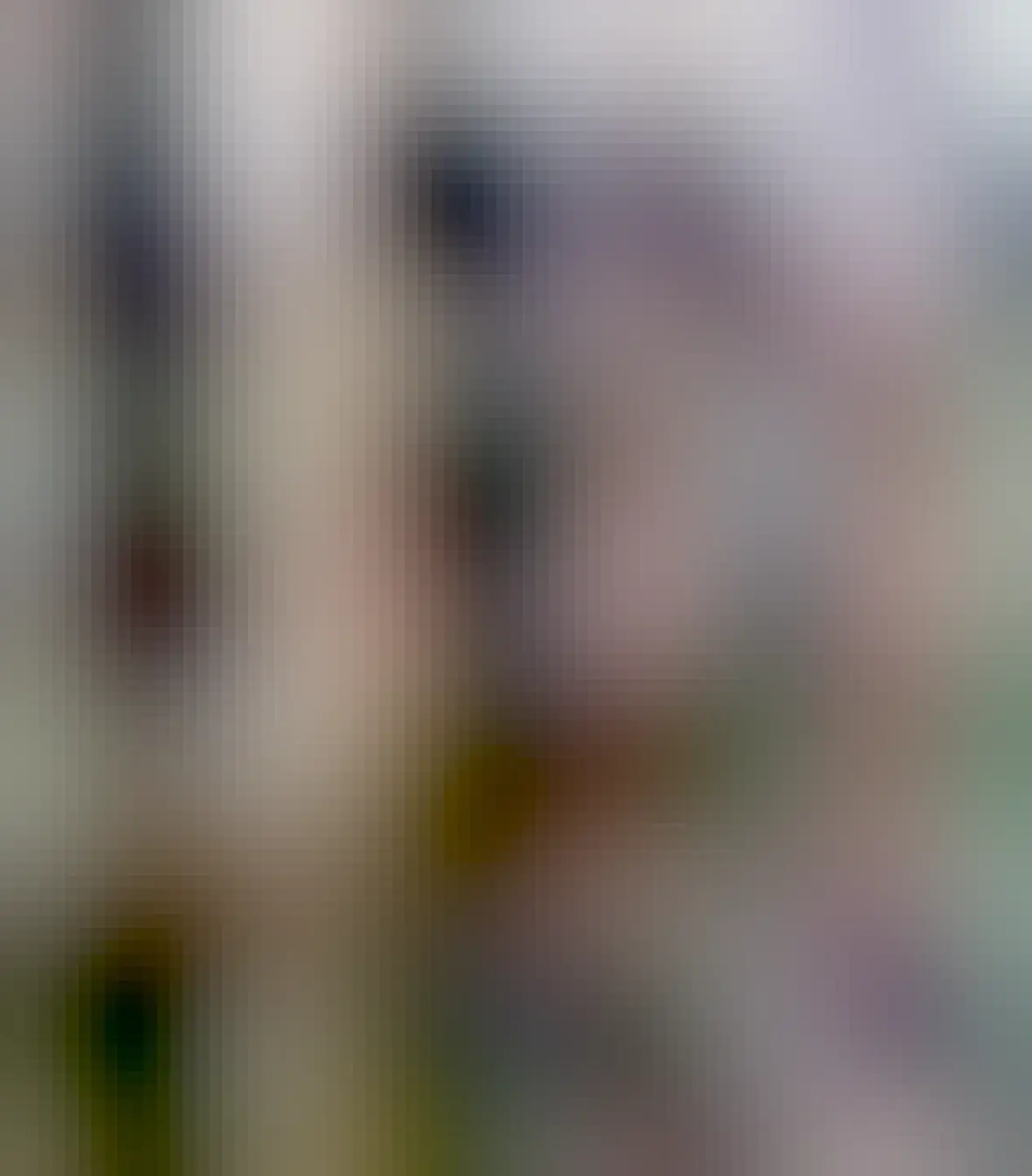 A car backed right up to a fence, but the fence has been modified so it bows out, allowing the car’s ass to fit 