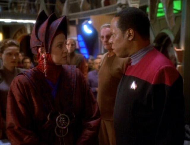 Vedek Winn and Commander Sisko stare each other down.