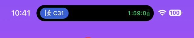 A screenshot of the iPhone Pro’s dynamic island showing a gate number and countdown to board