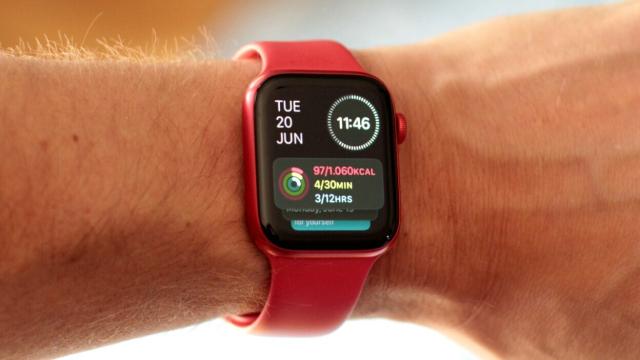 A photo stolen from Mashable of a wrist wearing a red Apple Watch showing the new Smart Stack view that includes the date, time, and a stack of scrollable widgets.