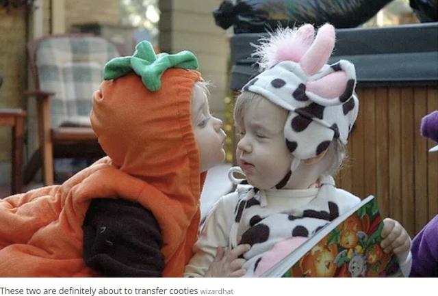 Photo by Wizardhat.
Image used by Smithsonian Magazine.

Two toddlers in fancy dress: a little boy dressed as a pumpkin, a little girls as a cow.
The boy is about to kiss the girl, she has her eyes closed.