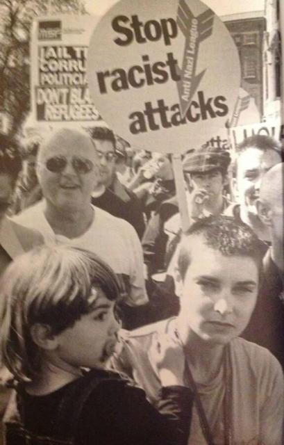 Sinéad O'Connor, holding her toddler son, on an anti-racist march in support of refugees, late 1980s.