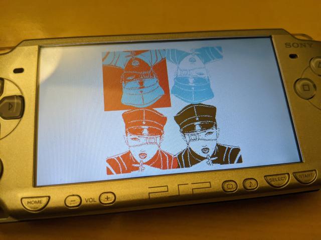 A PlayStation Portable showing an image of a woman's face mirrored in 4 directions demonstrating the new Varvara sprite flip support.