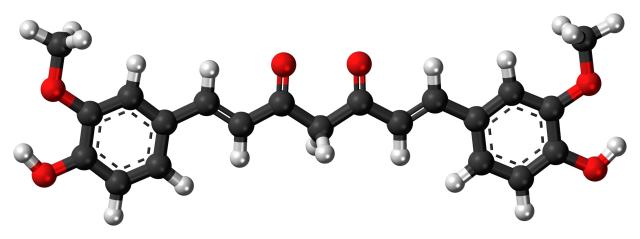 A ball and stick model of the keto form of curcurmin: a chain of 7 carbons capped at each end by benzene rings and methyl groups, with a total of 6 oxygen atoms as well.  From here:

https://commons.wikimedia.org/wiki/File:Curcumin-keto-3D-balls.png