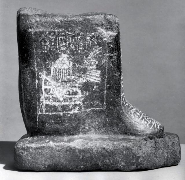 Block Statue of Ipwer; the right side shows the sacred boat of Sokaris.

Creative Commons-BY (Photo: Brooklyn Museum, CUR.36.738_negA_bw.jpg). Color and cropping edits.