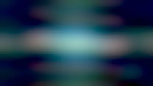 A red-tinged ring of dust is seen nearly on edge. In the ring's center and extending around the frame, blue gas and stars are shown.