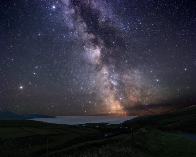 "St. Finnians' Bay in the UNESCO protected Ballinskelligs in the Kerry Dark Sky Reserve."

Photoneill, CC BY 4.0, via Wikimedia Commons. Color edits.