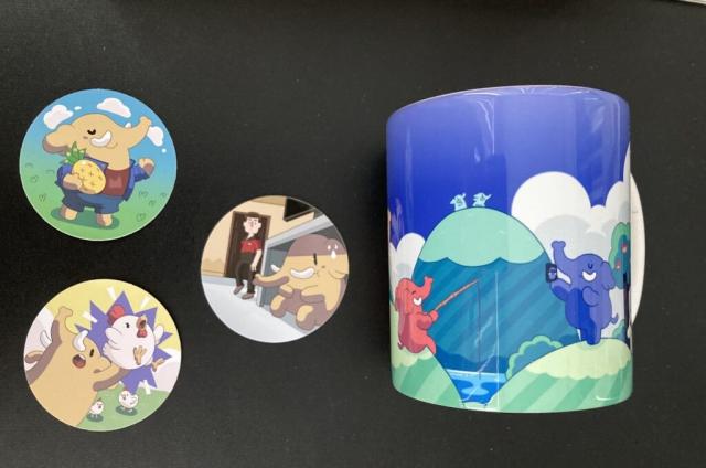 three Mastodon vinyl stickers and a Mastodon mug on its side