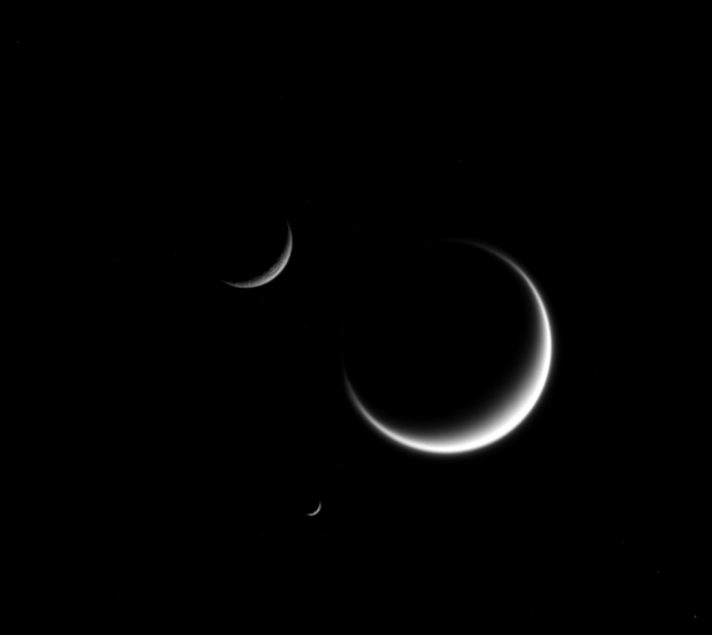 "PIA18322: Saturn Moons - 3 Crescents - Titan, Mimas, and Rhea."

NASA/JPL-Caltech/Space Science Institute, Public domain, via Wikimedia Commons.