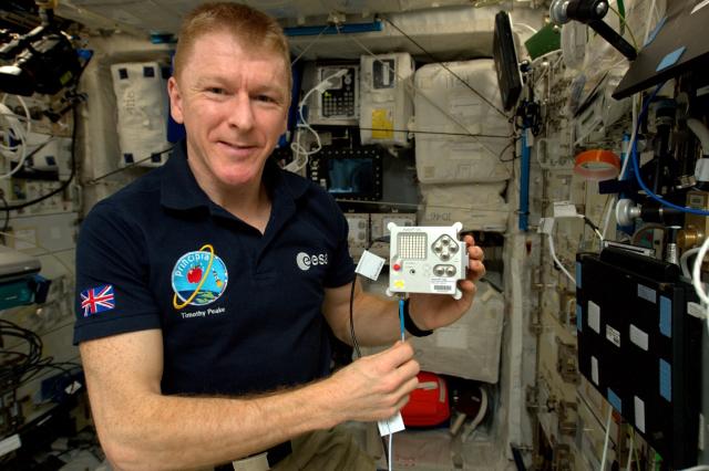 ESA astronaut Tim Peake holding the  Astro Pi VIS flight unit while on board the ISS