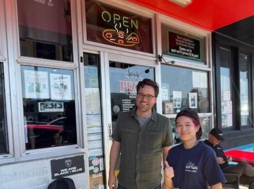 Picture of me and an employee at A Slice of New York pizzeria