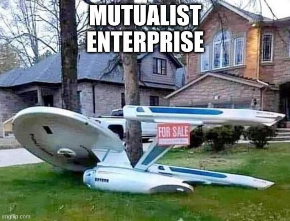 A large model of the USS Enterprise from Star Trek in the front lawn of a large suburban house with a "FOR SALE" sign. In meme text at the top, it says, "MUTUALIST ENTERPRISE."