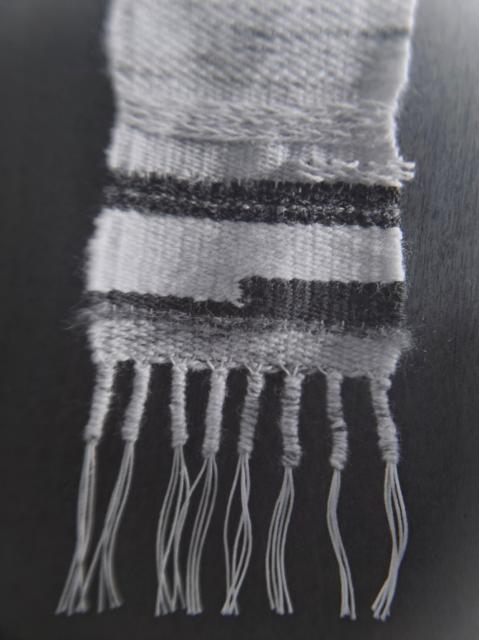 Black and white photo of fiber arts piece hanging. Closeup.