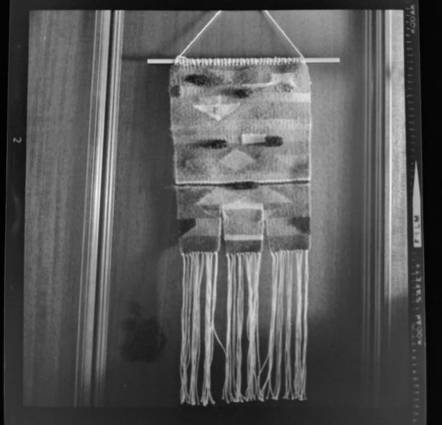 Black and white photo of fiber arts piece hanging.