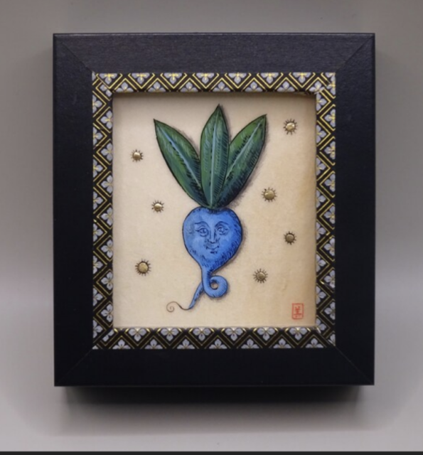 A hand painted image of a blue turnip with a face and three green leaves, surrounded by gold accents all done in a Medieval illuminated manuscript style. The painting is in a black and gold frame.