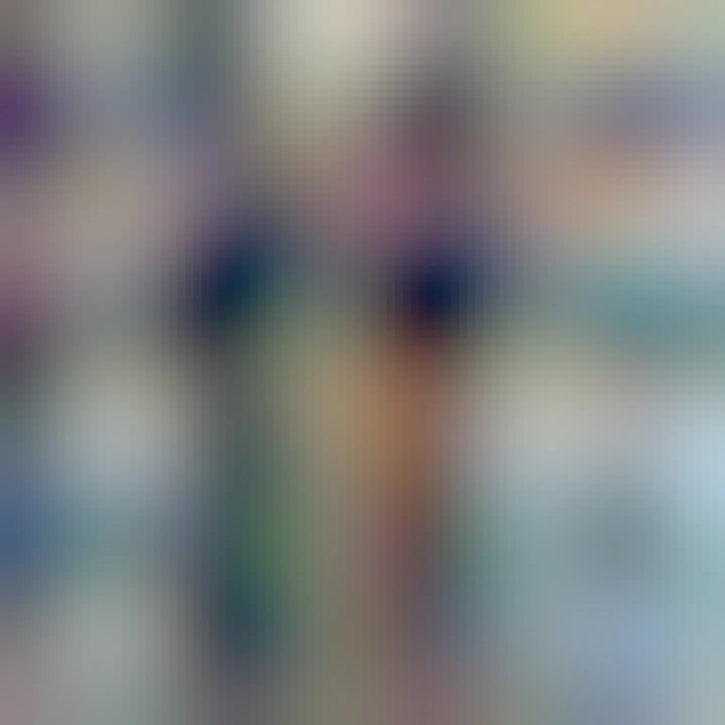 Mug decorated with a landscape and several mastodon mascots, with a butter thin resting against it. 