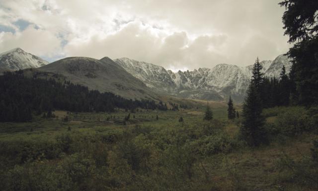 View of a mountain range with cloudy skies.