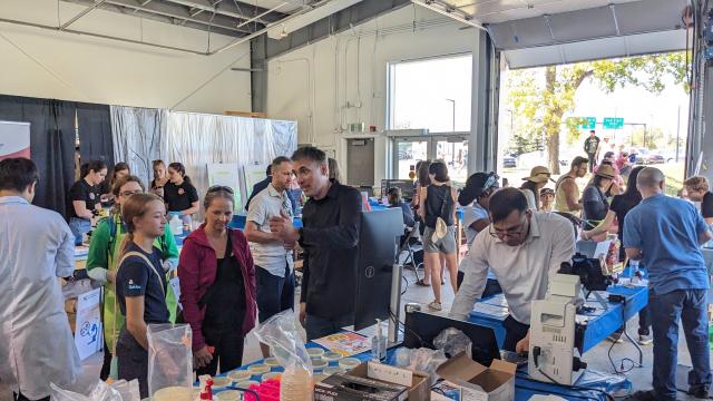 A crowd of people looking at science activities 